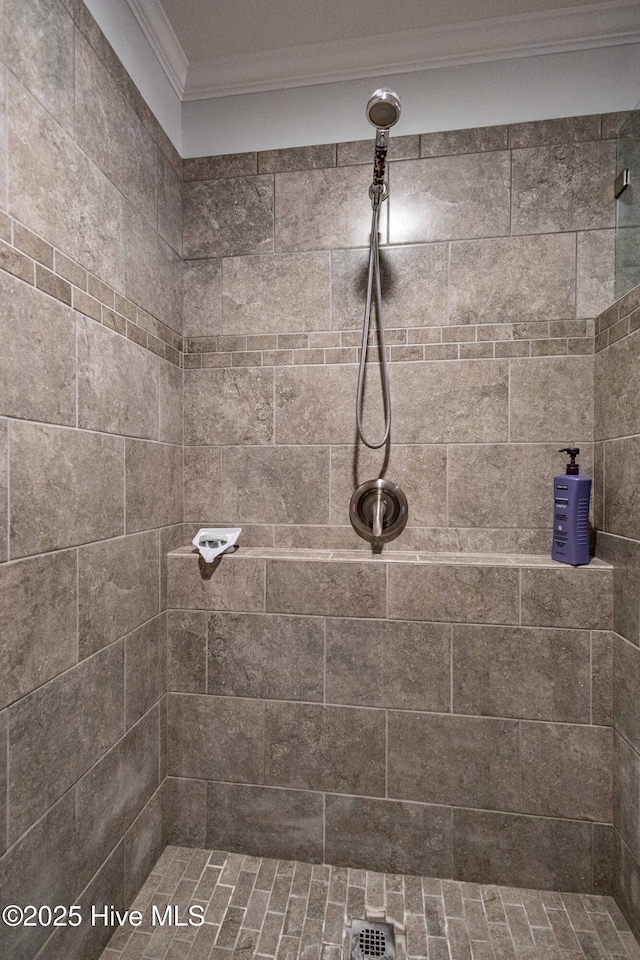 full bath with crown molding and tiled shower