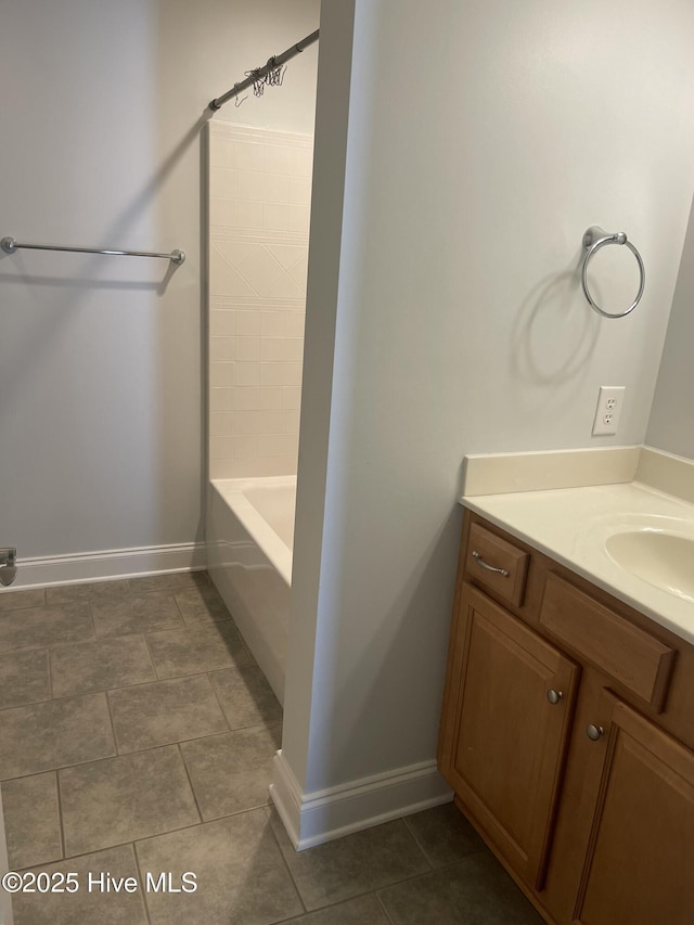 bathroom with baseboards, tile patterned flooring, and vanity