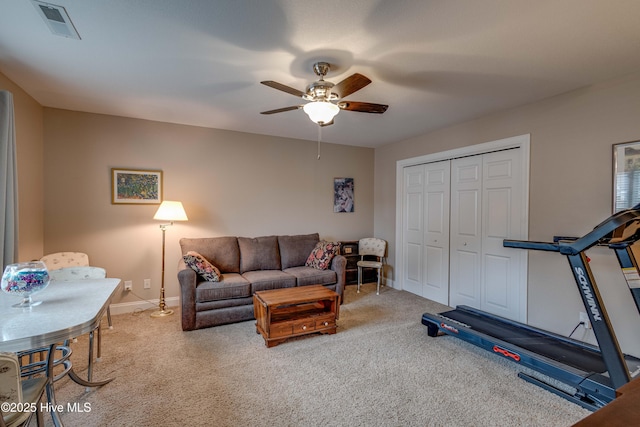 carpeted living area with visible vents, ceiling fan, and baseboards