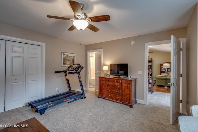 workout room with ceiling fan and carpet flooring