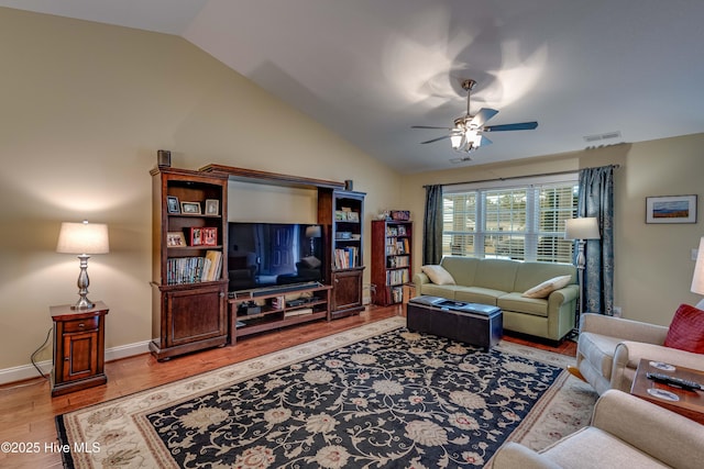 living room with visible vents, baseboards, a ceiling fan, light wood-style flooring, and vaulted ceiling