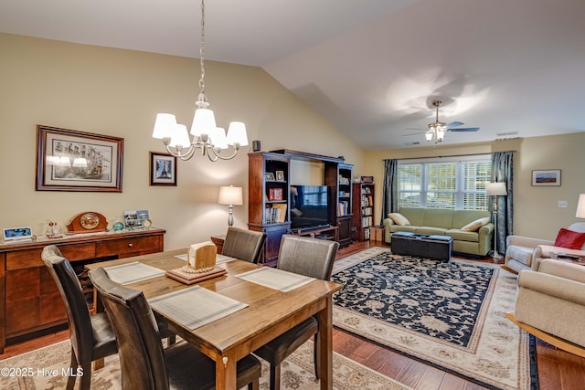 dining area with light wood-type flooring, vaulted ceiling, and ceiling fan with notable chandelier