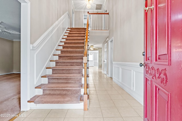 1611 Gores Landing Rd SW ., Unit Ocean Isle Beach, NC 28469 - tiled entrance foyer featuring wainscoting, ornamental molding, a decorative wall, and stairway