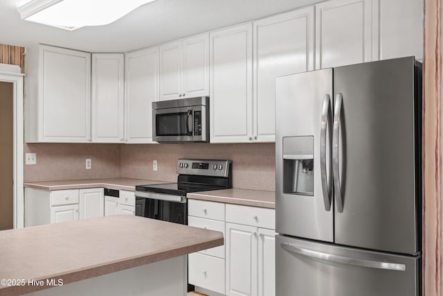 1611 Gores Landing Rd SW ., Unit Ocean Isle Beach, NC 28469 - kitchen with white cabinetry, light countertops, and appliances with stainless steel finishes