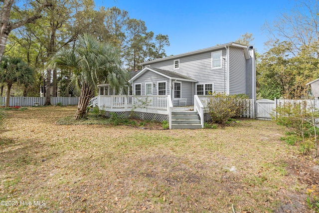 1611 Gores Landing Rd SW ., Unit Ocean Isle Beach, NC 28469 - back of property featuring a yard, a gate, fence, and a wooden deck