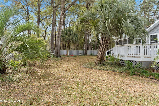 1611 Gores Landing Rd SW ., Unit Ocean Isle Beach, NC 28469 - view of yard with a sunroom, a deck, and fence