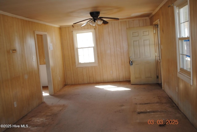 unfurnished room with crown molding and a ceiling fan