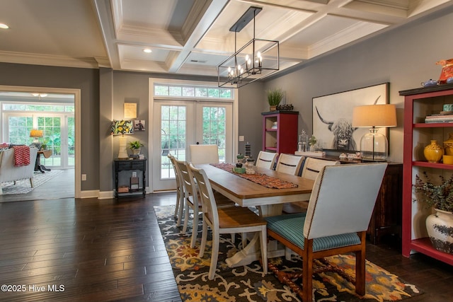 dining area featuring plenty of natural light, wood-type flooring, coffered ceiling, and french doors