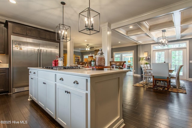 kitchen featuring coffered ceiling, beamed ceiling, dark wood-type flooring, a center island, and stainless steel appliances