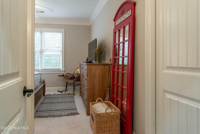 interior space featuring carpet, visible vents, crown molding, and baseboards