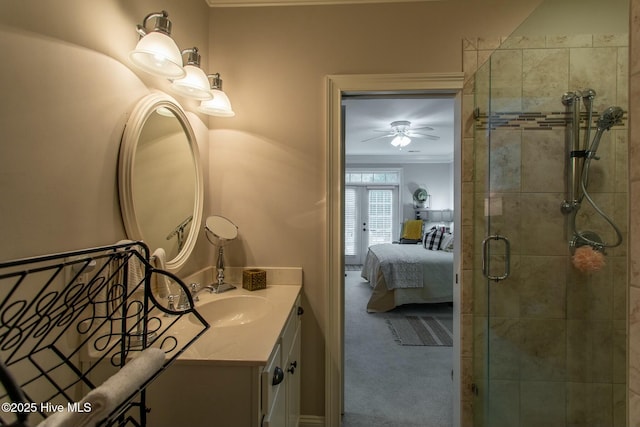 ensuite bathroom featuring a ceiling fan, ornamental molding, ensuite bathroom, a tile shower, and vanity