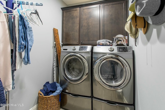 laundry room featuring independent washer and dryer and cabinet space