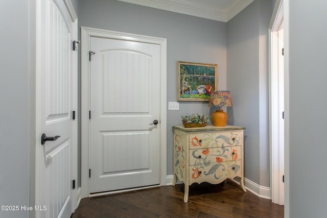 corridor featuring ornamental molding, dark wood finished floors, and baseboards