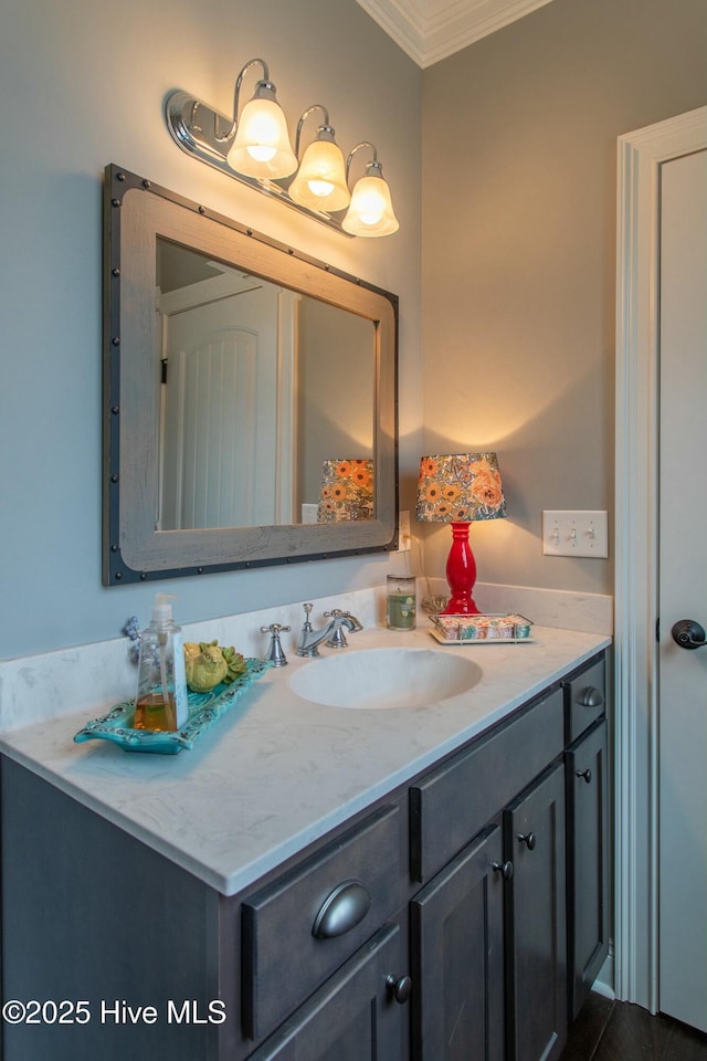 bathroom featuring crown molding and vanity