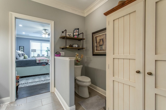 bathroom featuring connected bathroom, tile patterned flooring, crown molding, and toilet