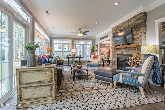 sunroom featuring a fireplace, visible vents, and a ceiling fan