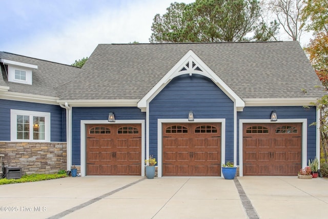 garage with concrete driveway