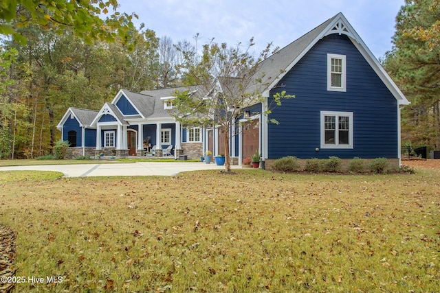 view of front of house featuring stone siding and a front lawn