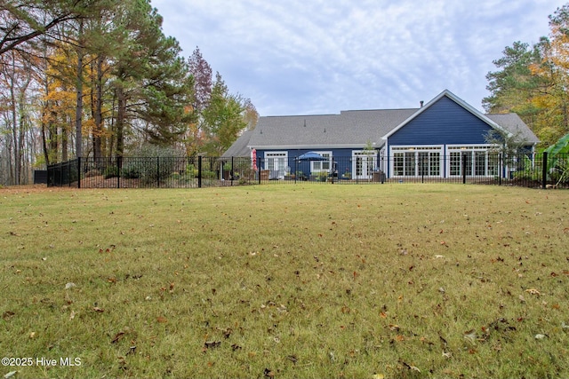 back of property with fence and a yard