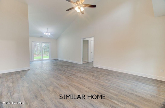 empty room featuring high vaulted ceiling, a ceiling fan, baseboards, and wood finished floors