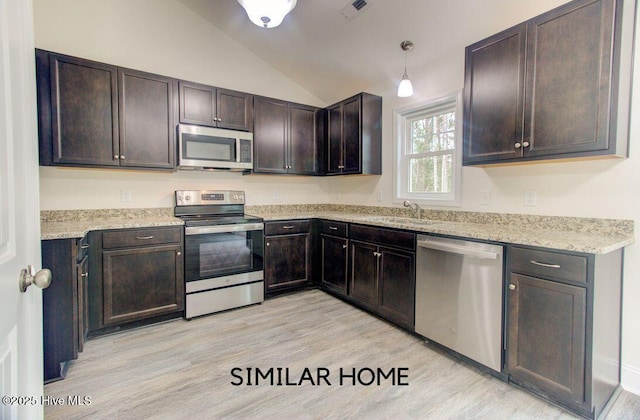 kitchen featuring lofted ceiling, light wood-style flooring, dark brown cabinetry, stainless steel appliances, and visible vents