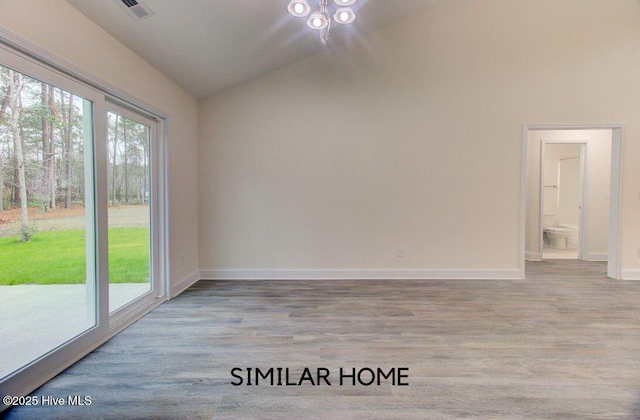 empty room featuring lofted ceiling, baseboards, visible vents, and light wood-style floors