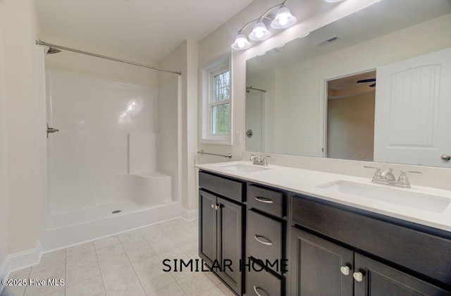 bathroom featuring a shower, tile patterned flooring, visible vents, and a sink