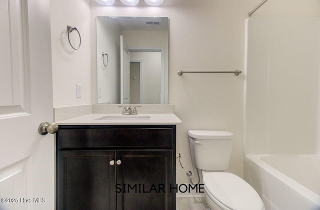 bathroom featuring toilet, visible vents, and vanity