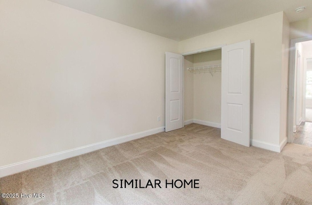 unfurnished bedroom featuring carpet, a closet, and baseboards