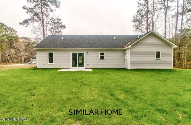 back of house with a patio area, a shingled roof, and a lawn