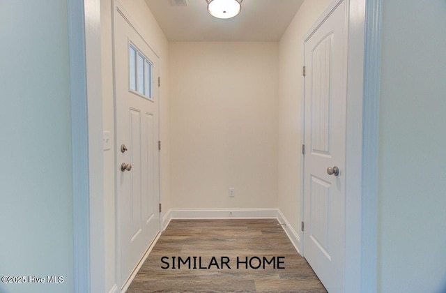 entryway with visible vents, baseboards, and wood finished floors