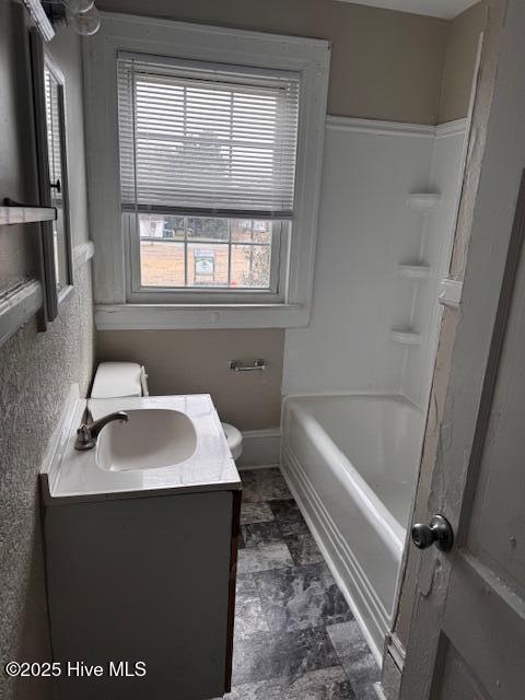 full bath featuring toilet, baseboards, and vanity