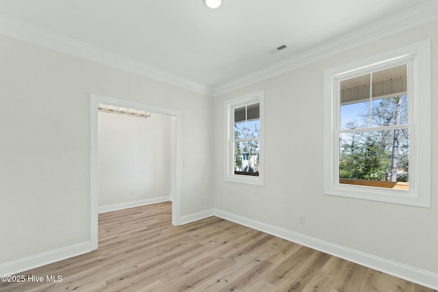 7103 E Yacht Dr, Oak Island, NC 28465 - empty room featuring light wood finished floors, visible vents, crown molding, and baseboards