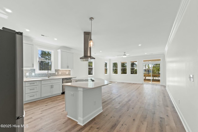 7103 E Yacht Dr, Oak Island, NC 28465 - kitchen featuring extractor fan, decorative backsplash, appliances with stainless steel finishes, white cabinetry, and a sink