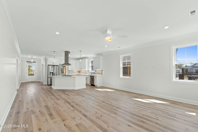 7103 E Yacht Dr, Oak Island, NC 28465 - unfurnished living room featuring visible vents, ornamental molding, ceiling fan with notable chandelier, light wood-style floors, and baseboards