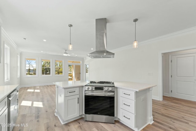 7103 E Yacht Dr, Oak Island, NC 28465 - kitchen with crown molding, wall chimney range hood, light countertops, and stainless steel appliances