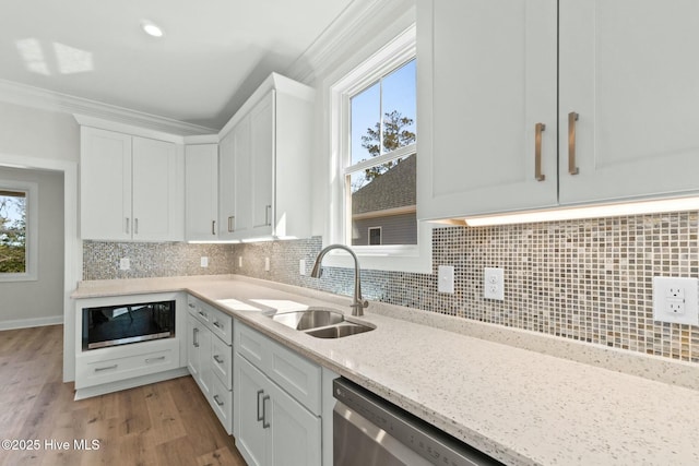 7103 E Yacht Dr, Oak Island, NC 28465 - kitchen featuring backsplash, ornamental molding, white cabinetry, and a sink