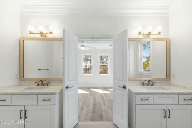 7103 E Yacht Dr, Oak Island, NC 28465 - full bath featuring a sink, two vanities, and ornamental molding