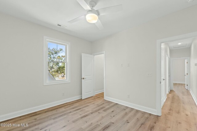 7103 E Yacht Dr, Oak Island, NC 28465 - unfurnished bedroom featuring attic access, light wood-style flooring, baseboards, and visible vents