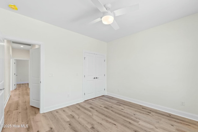 7103 E Yacht Dr, Oak Island, NC 28465 - unfurnished bedroom featuring visible vents, a ceiling fan, a closet, light wood finished floors, and baseboards