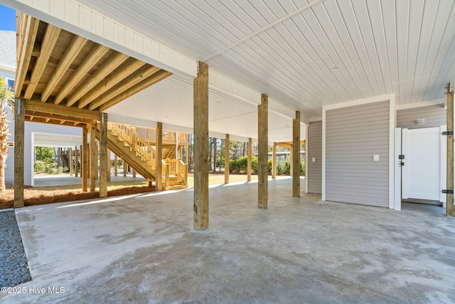 7103 E Yacht Dr, Oak Island, NC 28465 - view of patio / terrace featuring stairs and a carport