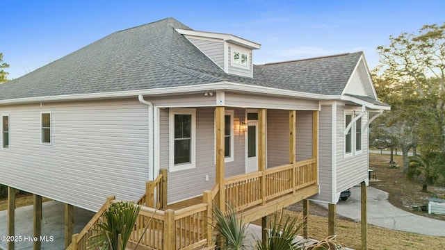 7103 E Yacht Dr, Oak Island, NC 28465 - exterior space with covered porch and a shingled roof