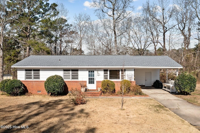 single story home featuring driveway, brick siding, roof with shingles, crawl space, and a front yard