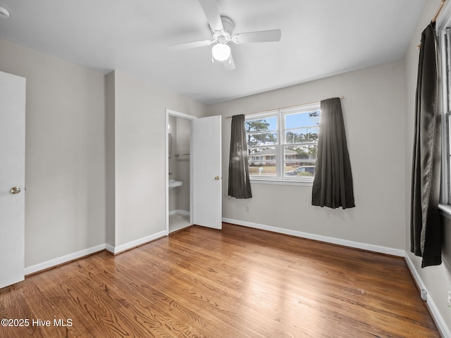 unfurnished bedroom featuring wood finished floors, a ceiling fan, and baseboards