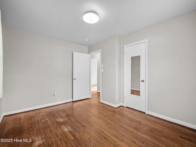 unfurnished bedroom featuring baseboards and wood finished floors