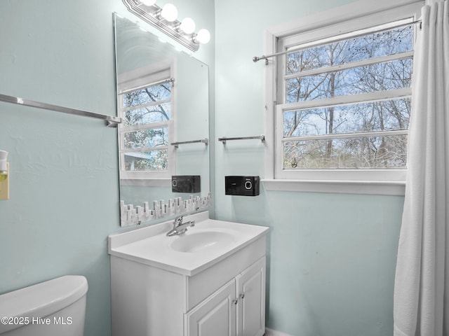 bathroom featuring toilet and vanity