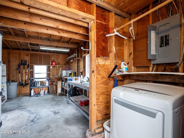 interior space with washer / clothes dryer, electric panel, and a workshop area