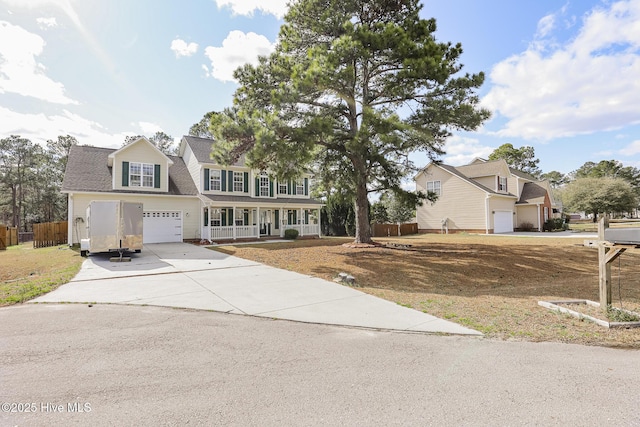 view of front of house featuring fence, driveway, covered porch, a shingled roof, and a garage