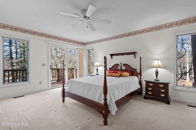 bedroom featuring a textured ceiling, visible vents, carpet, and access to outside