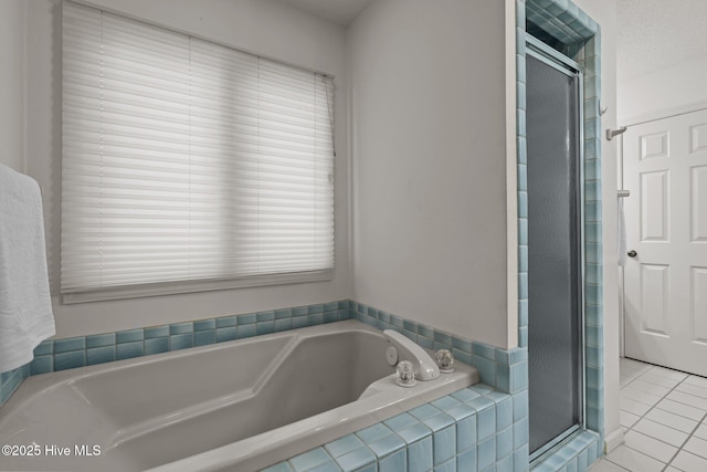 bathroom featuring tile patterned floors, a garden tub, and a shower stall